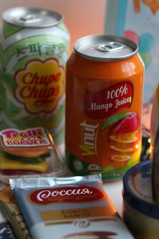 a variety of drinks and snacks on a table, inspired by Kim Jeong-hui, labels, up close, mango, shopping groceries