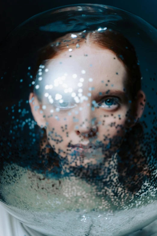 a close up of a person in a glass ball