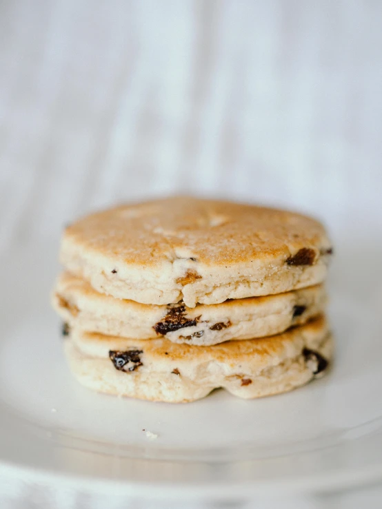 a stack of pancakes sitting on top of a white plate, by Emma Andijewska, white with chocolate brown spots, crispy buns, smol, 6 pack