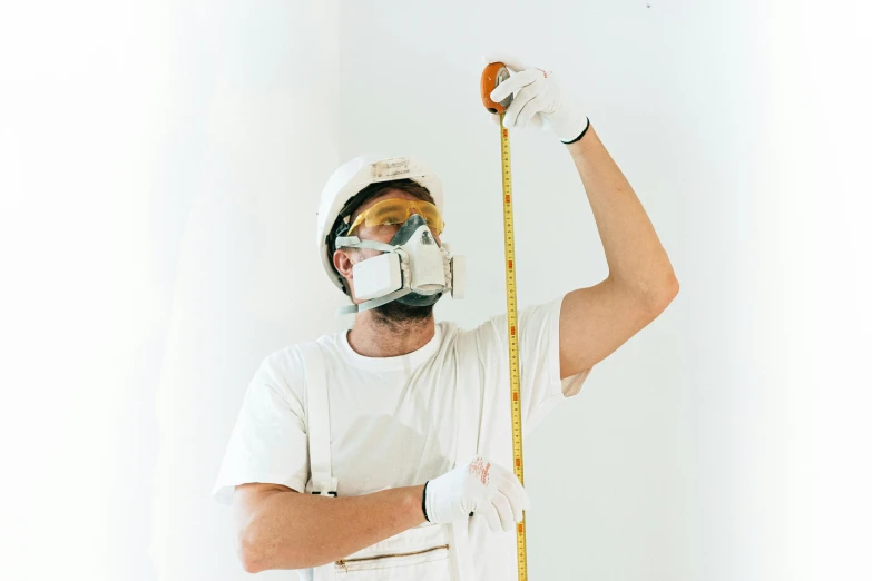 a man in a white shirt holding a tape measure, pexels contest winner, hyperrealism, wearing gas mask helmets, white walls, wearing plumber uniform, with height