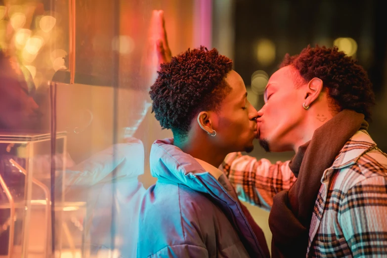 a man and woman kissing in front of a store window, trending on pexels, lgbt, essence, ashteroth, vivid lights