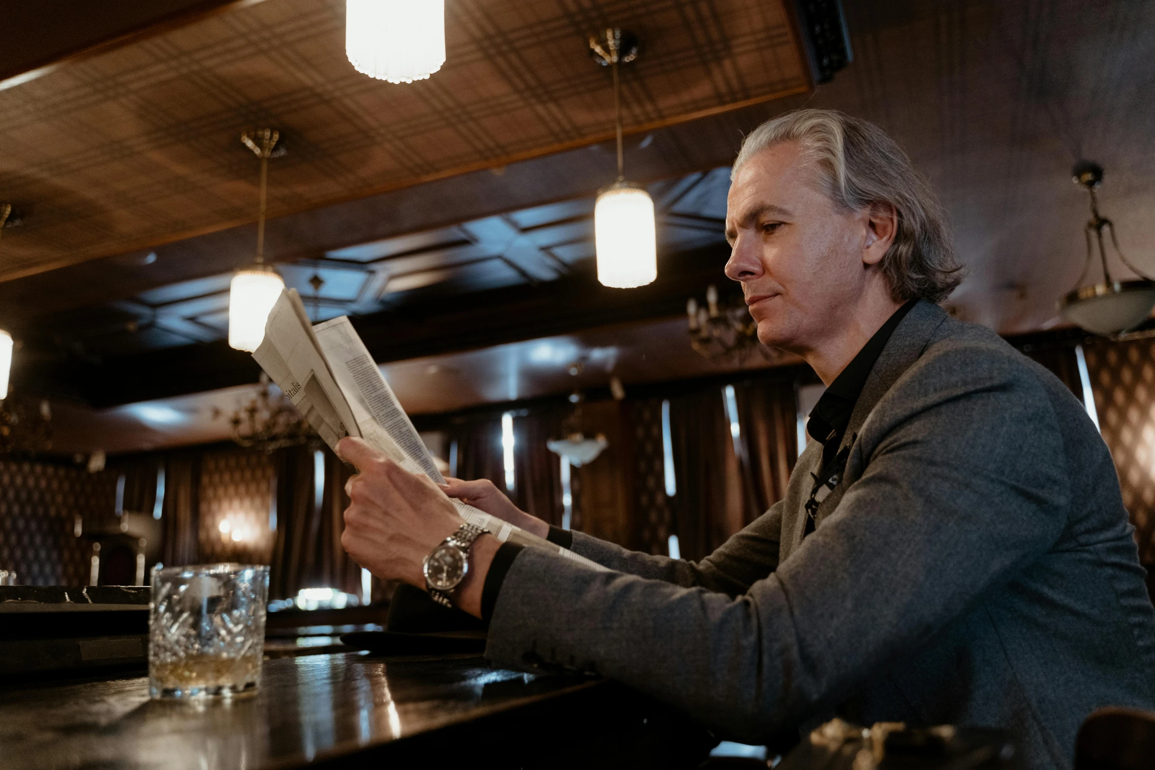 a man sitting at a bar reading a newspaper, a portrait, by Gavin Hamilton, unsplash, private press, henrik fisker, a silver haired mad, david spade, thumbnail