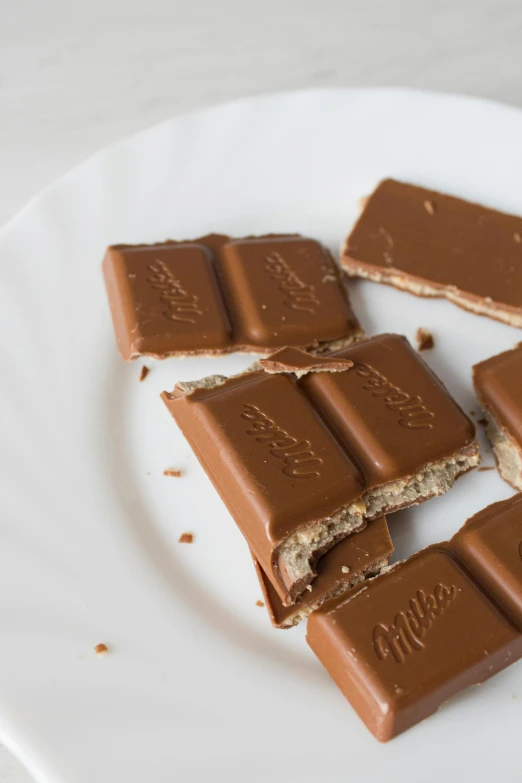 a white plate topped with pieces of chocolate, 6 pack, mars candy bars, thumbnail, chicago