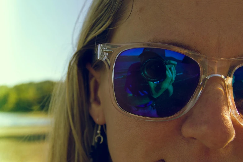 a close up of a person wearing sunglasses, a picture, lens flair, emily rajtkowski, close up to the screen, coloured photo