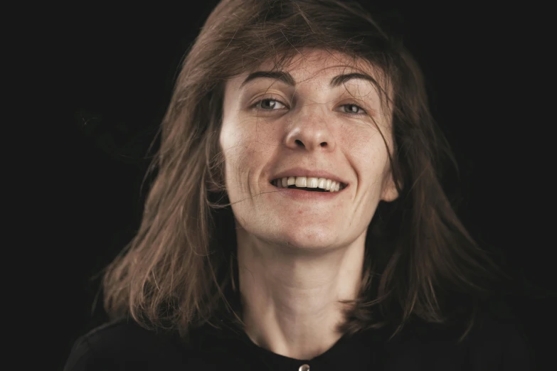 a woman standing in front of a black background, hyperrealism, winking at the camera, close-up portrait film still, plain background, 30-year-old french woman