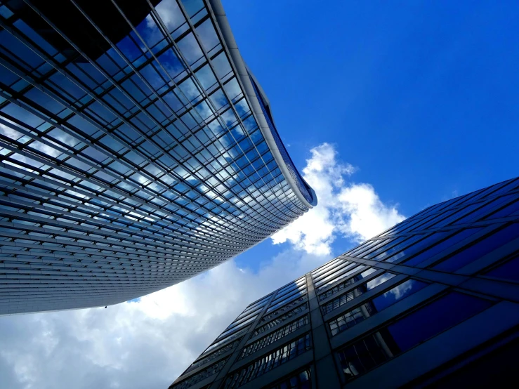 a couple of tall buildings that are next to each other, inspired by Zaha Hadid, pexels contest winner, bauhaus, sky blue, square, thumbnail, worm\'s eye view