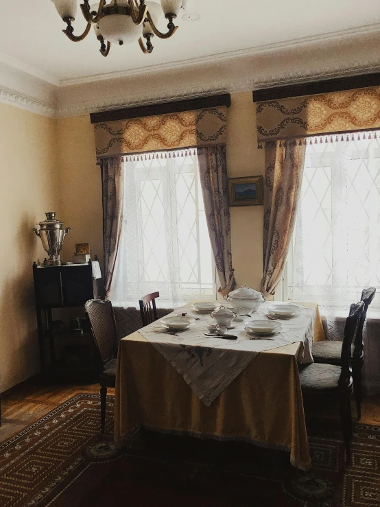 a dining room with a table and chairs, a portrait, inspired by Vasily Polenov, unsplash, low quality photo, historical footage, tablecloth, tourist photo