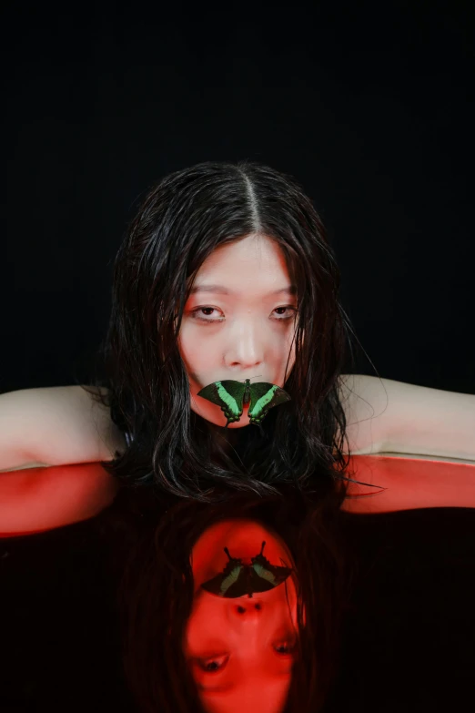 a woman with a green leaf in her mouth, an album cover, inspired by Taro Yamamoto, unsplash, red velvet, butterfly, gongbi, halloween
