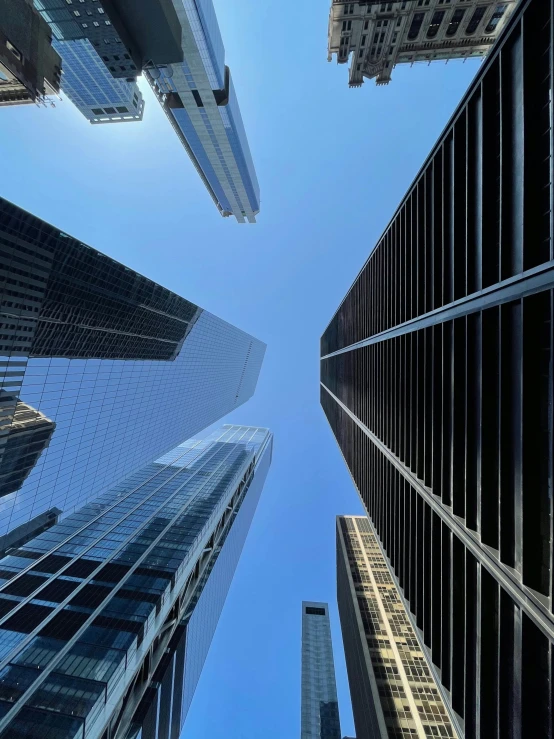 a group of tall buildings in a city, by David Donaldson, pexels contest winner, upward perspective, clear sky above, ignant, 2 0 2 2 photo