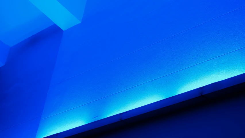 a wall that has some blue lights on it, inspired by Joseph Wright of Derby, unsplash, light and space, low angle photograph, medium blue, museum light, ((blue))