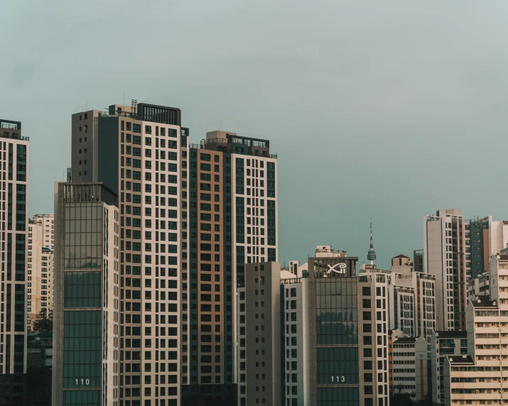 a group of tall buildings sitting next to each other, by Alejandro Obregón, manila, zoomed out view, multiple stories, desktop wallpaper