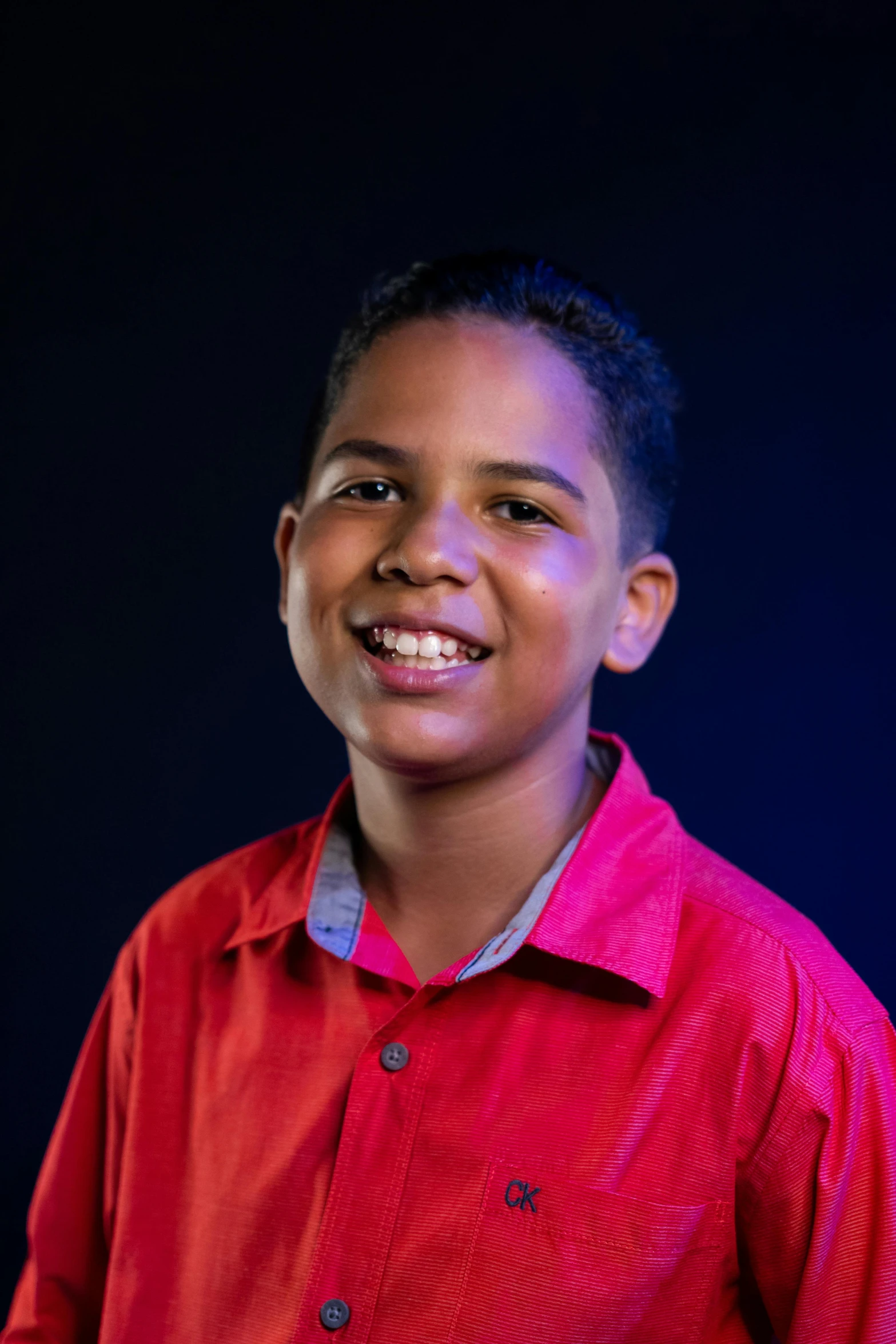 a young boy in a red shirt posing for a picture, with professional lighting, jordan lamarre - wan, digital image, african american