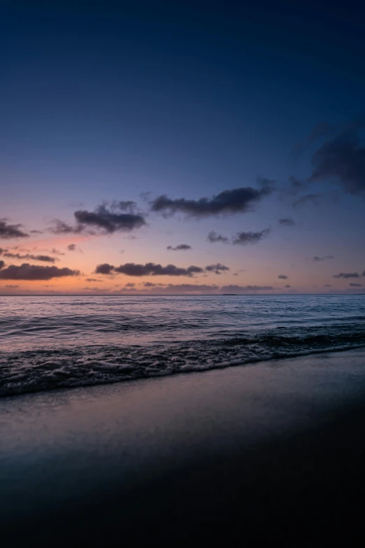 a large body of water sitting on top of a sandy beach, by Peter Churcher, during dawn, reunion island, today\'s featured photograph 4k, 8k photo