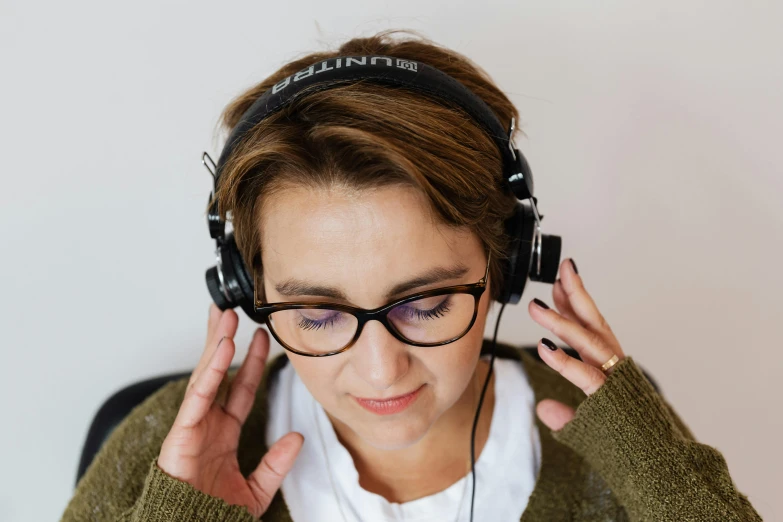 a close up of a person wearing headphones, trending on pexels, wearing reading glasses, avatar image, anna nikonova aka newmilky, thumbnail