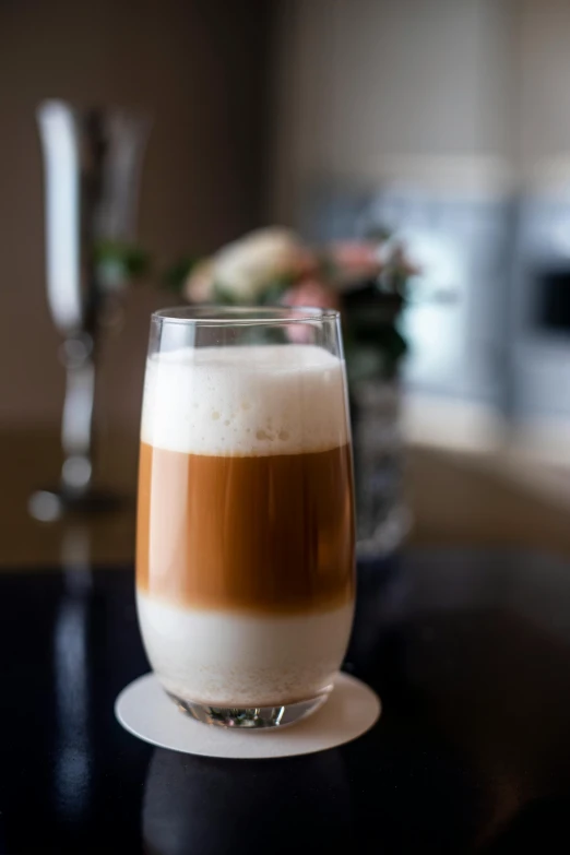 a glass of coffee sitting on top of a table, from the side, thumbnail, creamy, monaco