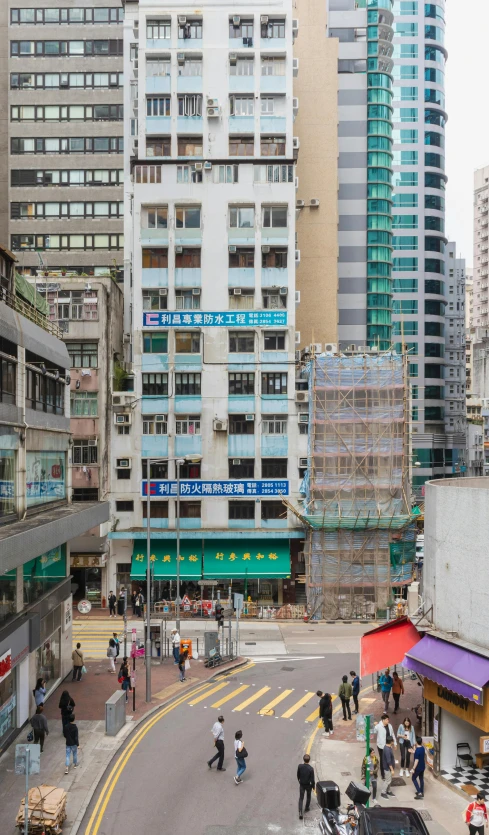 a group of people walking down a street next to tall buildings, shui mo hua, cinemascope panorama, storefront, seen from above