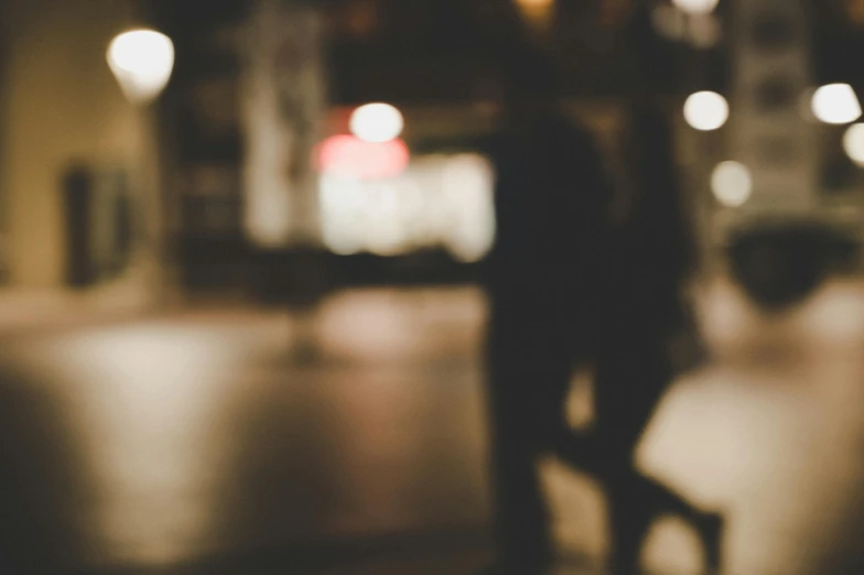 a blurry image of a person sitting on a bench, trending on unsplash, tonalism, man and woman walking together, nightlife, dark and beige atmosphere, bokeh )