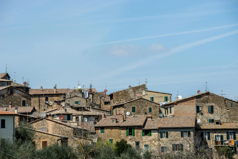 a group of buildings sitting on top of a hill, pexels contest winner, renaissance, mud and brick houses, orazio gentileschi style, blue sky, portrait image