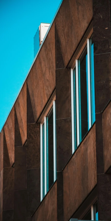 a traffic light hanging off the side of a building, by Tobias Stimmer, pexels contest winner, modernism, brown and cyan color scheme, sustainable materials, windows and walls :5, brown