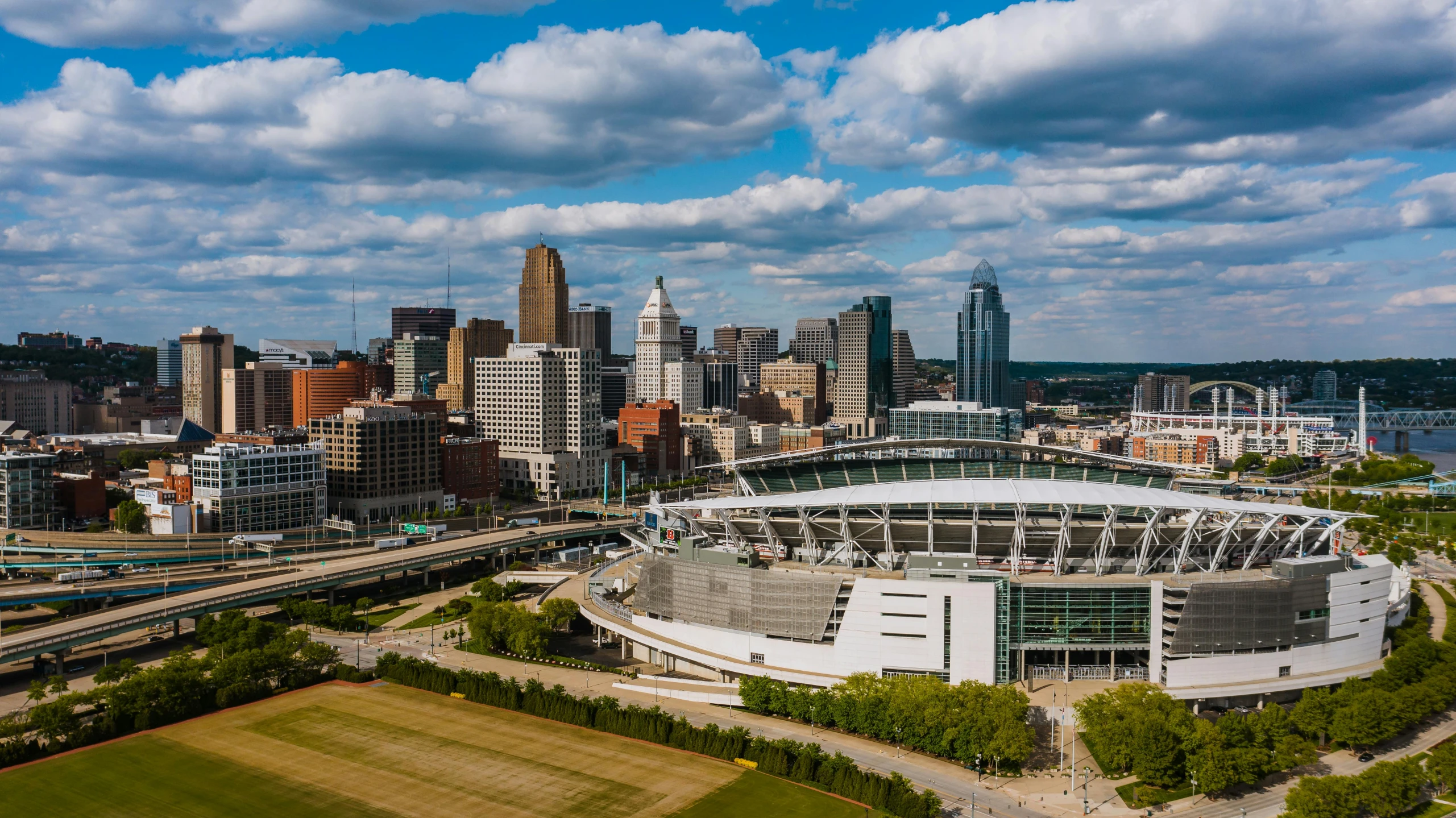 a large stadium in the middle of a city, by Ben Zoeller, pexels contest winner, ohio, wide panoramic shot, fan favorite, urban skyline