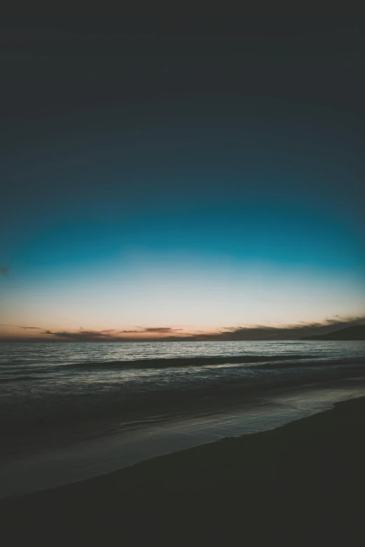 the sun is setting over the ocean on the beach, an album cover, unsplash, minimalism, multiple stories, night sky, low quality photo