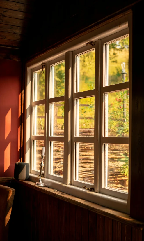 a chair sitting in front of a window in a room, inspired by Pieter de Hooch, pexels, arts and crafts movement, interior of a mountain hut, steel window mullions, autum, 15081959 21121991 01012000 4k