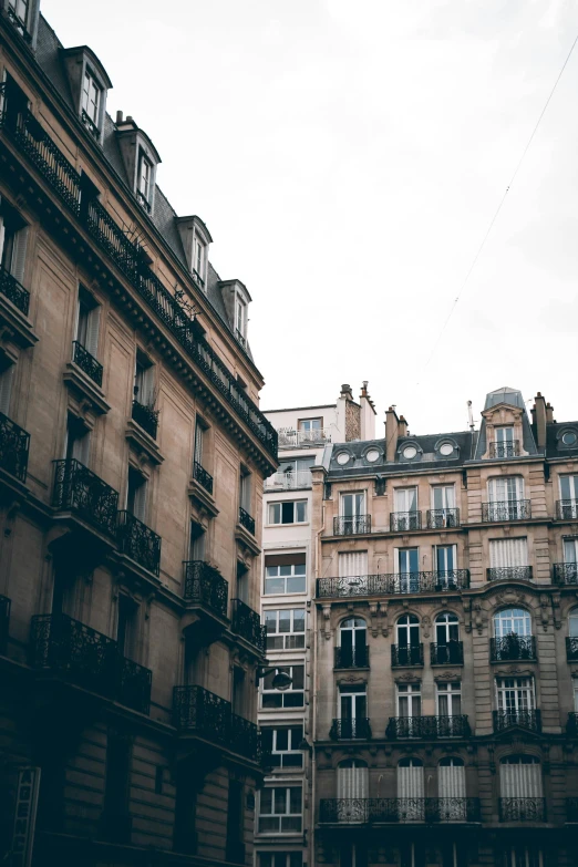 a couple of buildings that are next to each other, pexels contest winner, paris school, faded colors, city apartment cozy calm, uploaded, petite