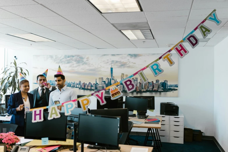 a group of people standing next to each other in an office, a colorized photo, unsplash, happening, barbarian celebrate his birthday, decorations, background image, adafruit