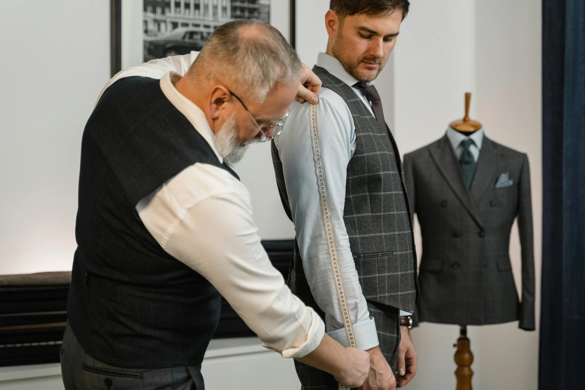 a couple of men standing next to each other, inspired by Harrington Mann, pexels contest winner, craftsmanship, grey suit, insisted on cutting in line, from back