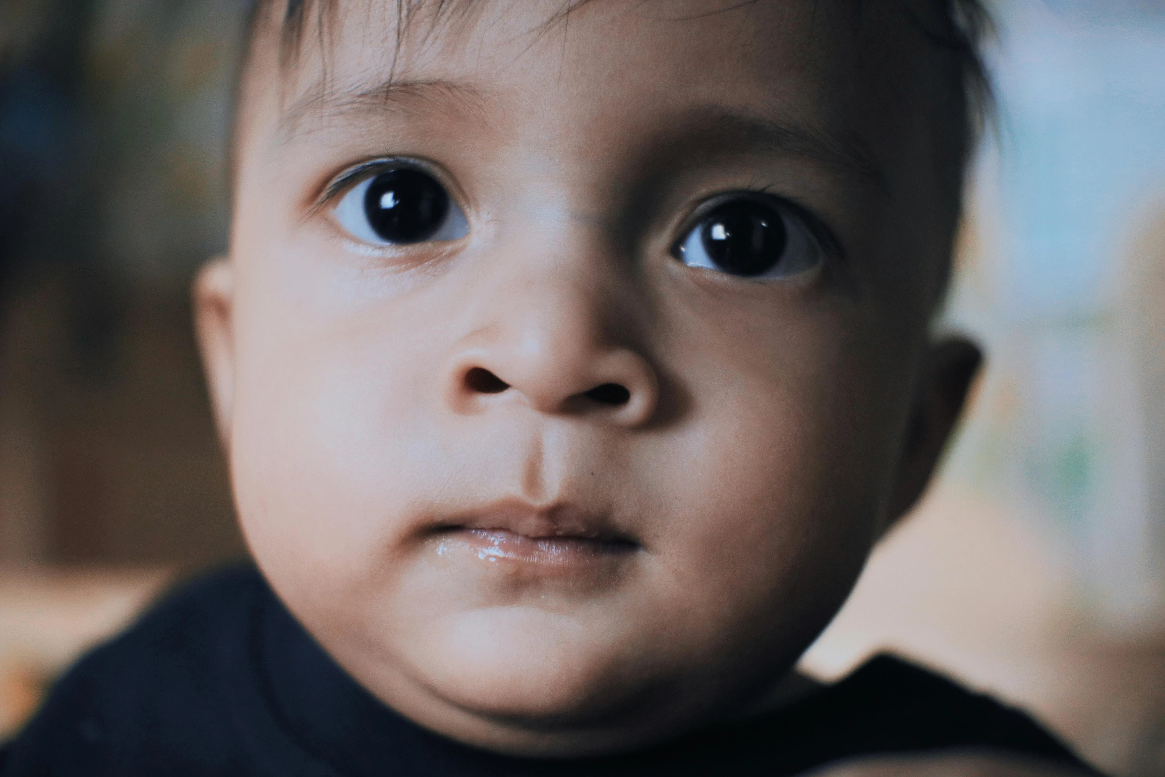 a close up of a baby wearing a black shirt, pexels contest winner, hyperrealism, an olive skinned, boyish face, extremely high resolution, pouty