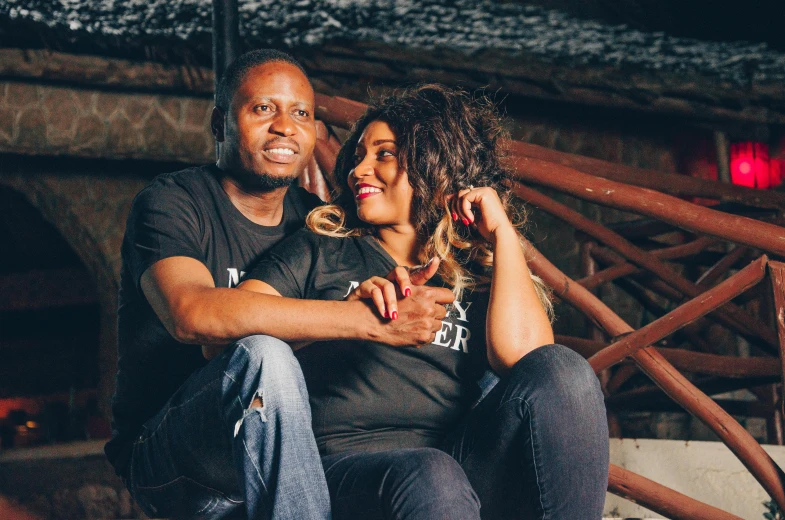 a man and a woman sitting next to each other, by Ella Guru, pexels contest winner, very kenyan, confident pose, official store photo, off camera flash