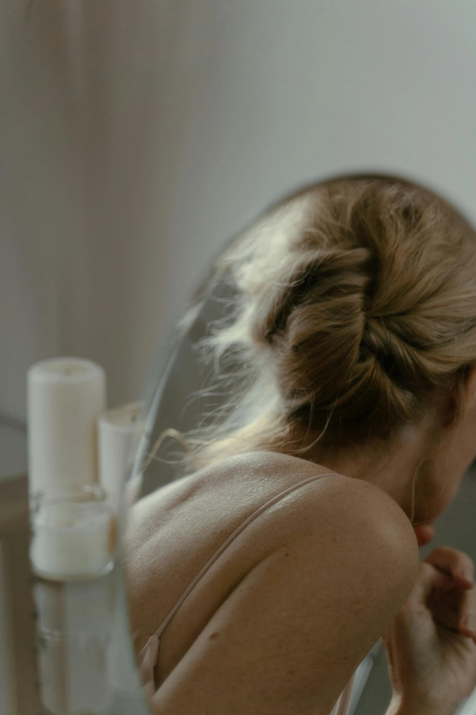 a woman brushing her teeth in front of a mirror, inspired by Nan Goldin, trending on pexels, renaissance, blond hair. ponytail, 4 k hd film still, face down, candlelit