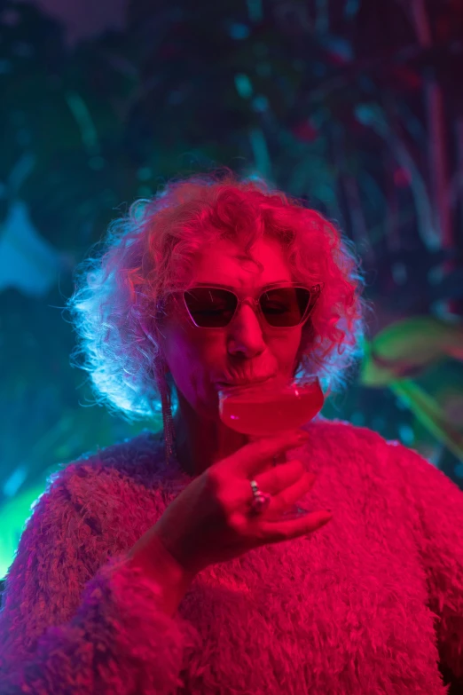 a close up of a person holding a cell phone, inspired by Nan Goldin, neo-fauvism, glam rockers drinking wine, older woman, tropics, perfectly lit. movie still