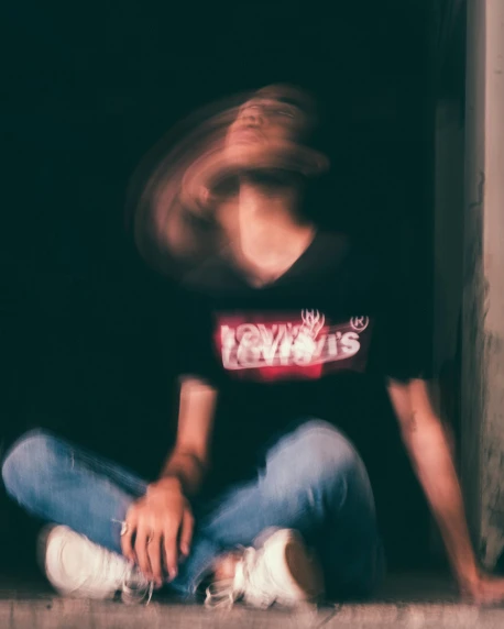 a blurry image of a person sitting on the ground, wearing a t-shirt, lysergic, bad vibes, jeans and t shirt