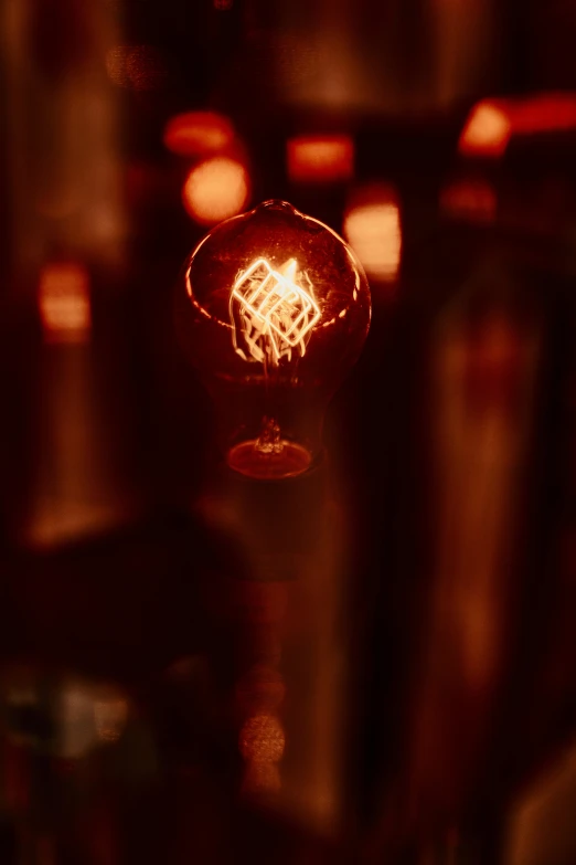 a close up of a light bulb in a dark room, by Robbie Trevino, synthetism, cozy dark 1920s speakeasy bar, tesla coil, reds, family photo