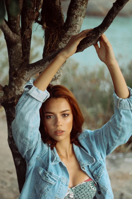 a beautiful young woman standing next to a tree, pexels contest winner, renaissance, wearing a jeans jackets, adriana lima, ginger hair, olive skin color