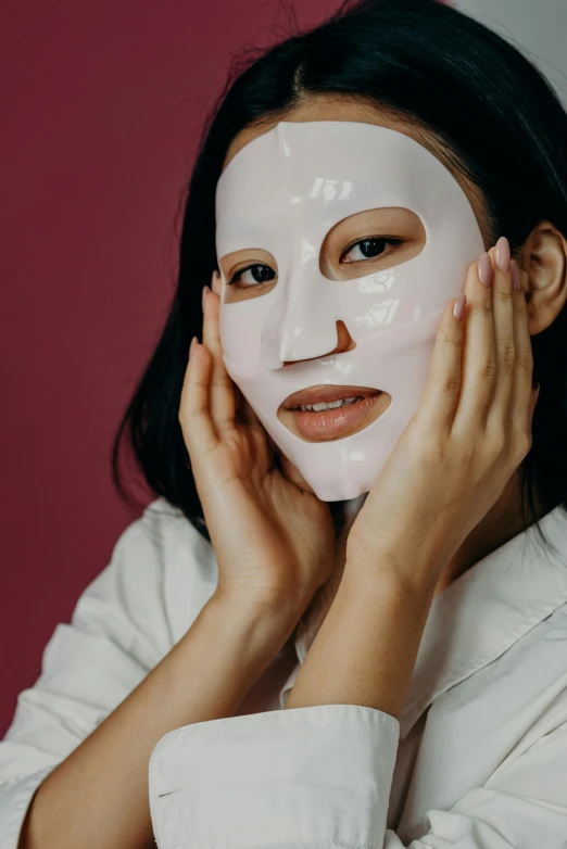 a woman with a white mask on her face, trending on pexels, asian face, latex flesh and facial muscles, smooth fuschia skin, korean