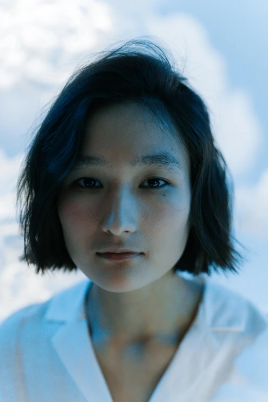 a woman in a white shirt looking at the camera, inspired by Jung Park, unsplash, young himalayan woman, bluish face, ishikei, low iso