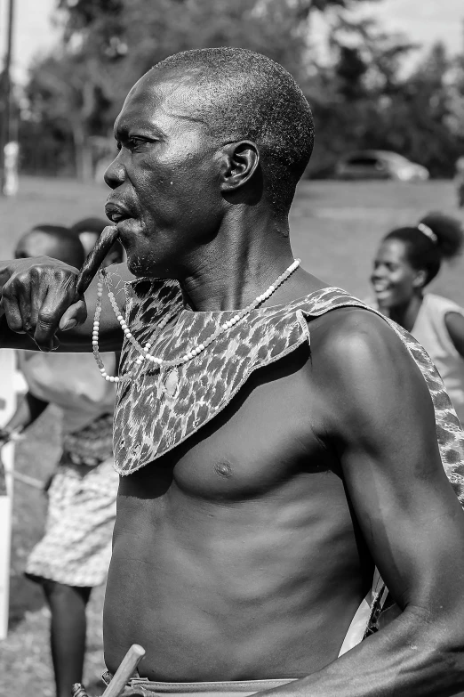 a black and white photo of a man brushing his teeth, by Arie Smit, pexels contest winner, happening, tribal dance, wearing shiny breastplate, people enjoying the show, outside