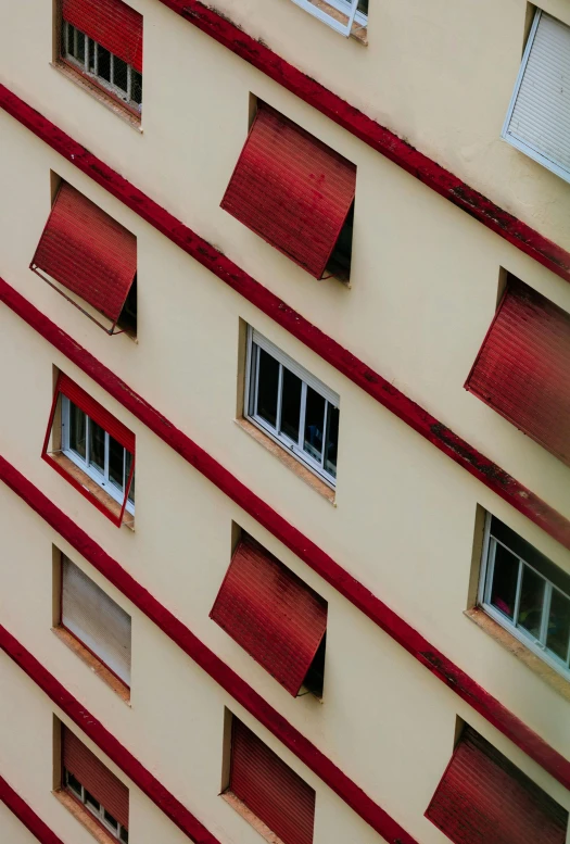 a tall red and white building with lots of windows, inspired by André Kertész, pexels contest winner, awnings, high angle close up shot, brown, neighborhood outside window