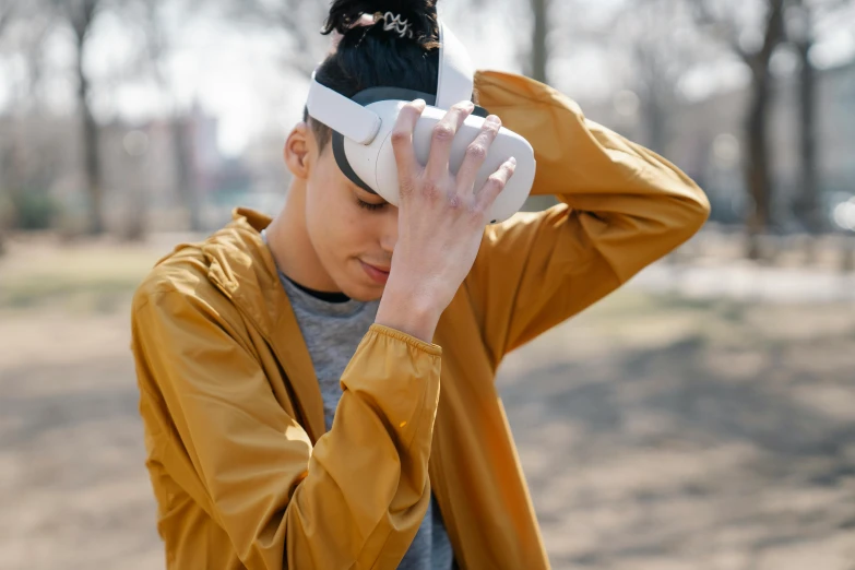 a close up of a person wearing a headband, a picture, trending on pexels, 3 d goggles, disappointed, at a park, wearing futuristic clothing