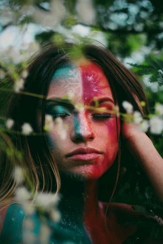 a woman with red and blue paint on her face, a colorized photo, inspired by Elsa Bleda, trending on pexels, color field, woman made of plants, half & half hair dye, hippie girl, symmetrical face and body