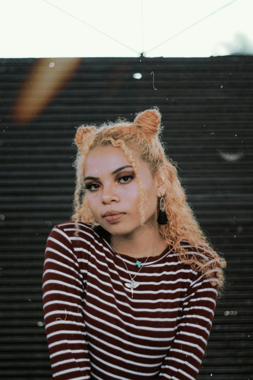 a woman with blonde hair wearing a striped shirt, an album cover, inspired by Elsa Bleda, trending on pexels, mixed race woman, cat ears, ear floof, 🤤 girl portrait