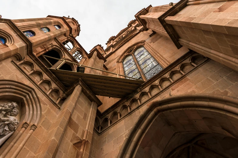 a very tall building with a clock on it's side, a photo, pexels contest winner, renaissance, gothic arch frame, brown, looking downwards, multiple wide angles