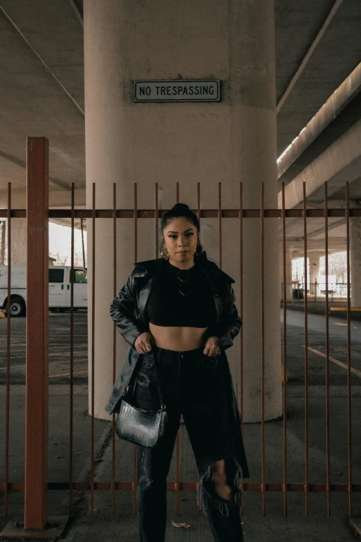 a woman standing in an empty parking garage, an album cover, by Robbie Trevino, trending on pexels, total black outfit, holding a leather purse, thicc, asian women