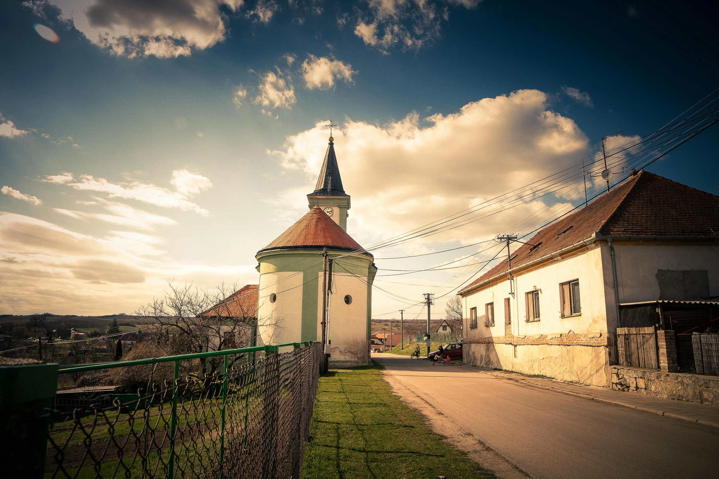 a small church sitting on the side of a road, by Adam Szentpétery, pexels contest winner, renaissance, afternoon light, panorama, southern slav features, retro vibe