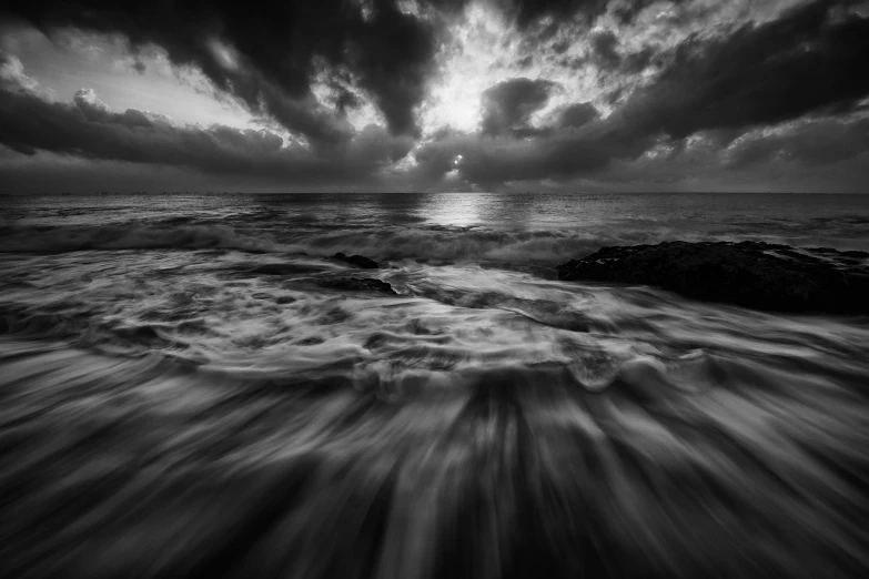 a black and white photo of the ocean, a black and white photo, by Daniel Gelon, unsplash contest winner, dramatic storm sunset, caught in the flow of time, today\'s featured photograph 4k, great fantasy mood