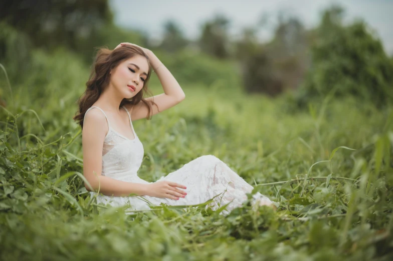 a woman sitting on top of a lush green field, white dress, clean face and body skin, trending on imagestation, solo photoshoot