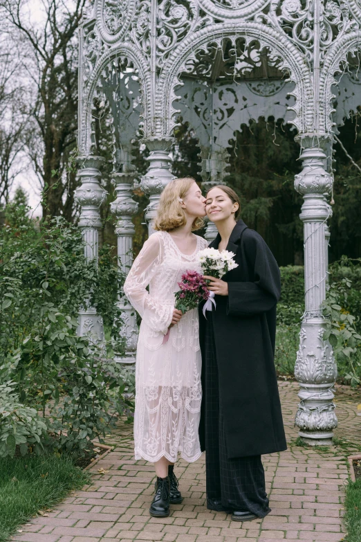 a couple of women standing next to each other in front of a gazebo, unsplash, romanticism, sleek robes, official screenshot, bouquet, kiko mizuhara