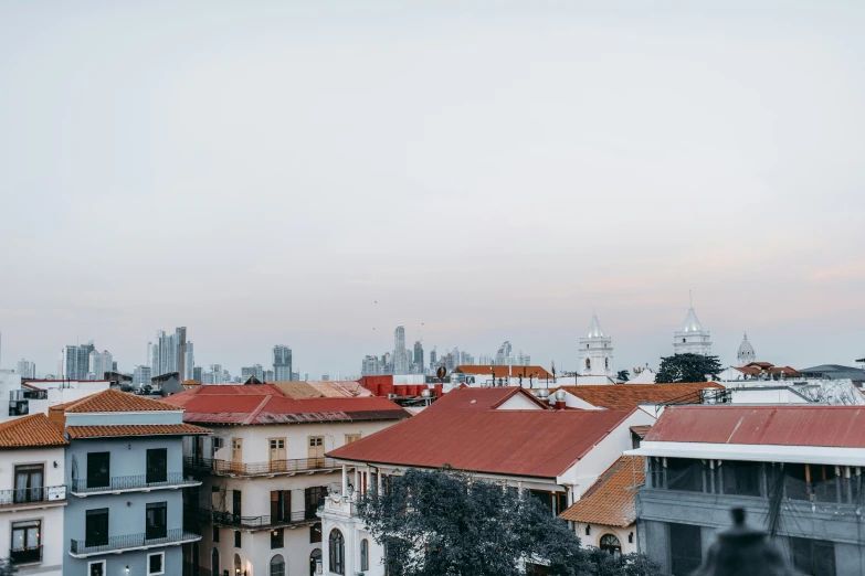 a view of a city from the top of a building, inspired by Ceferí Olivé, pexels contest winner, colonial, background image, 6 : 3 0 am, karolina cummings